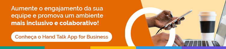 Imagem demonstra uma mão segurando um celular, em frente a um computador. Letras em destaque dizem "Aumente o engajamento da sua equipe e promova um ambiente mais inclusivo e colaborativo! Conheça o Hand Talk App for Business",