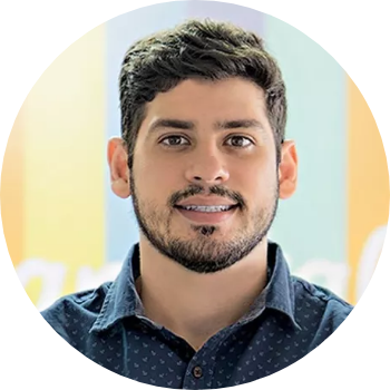 Round picture of Ronaldo Tenório, CEO of Hand Talk. It shhows his head, smiling. He is a white man with brown short hair, has a mustache and a beard, and is wearing a navy blue shirt.